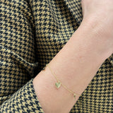 Złota bransoletka na łańcuszku z zawieszkami z różnym motywem